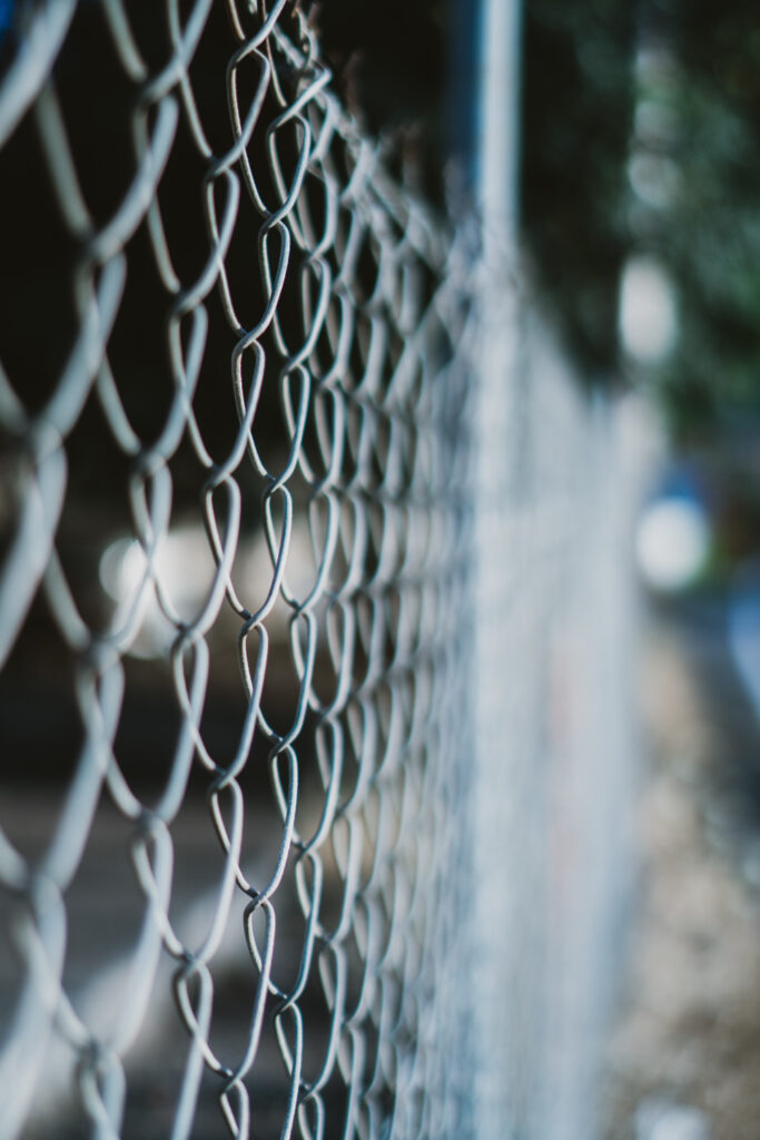 vertical-shot-wired-fence-with-blurred-background